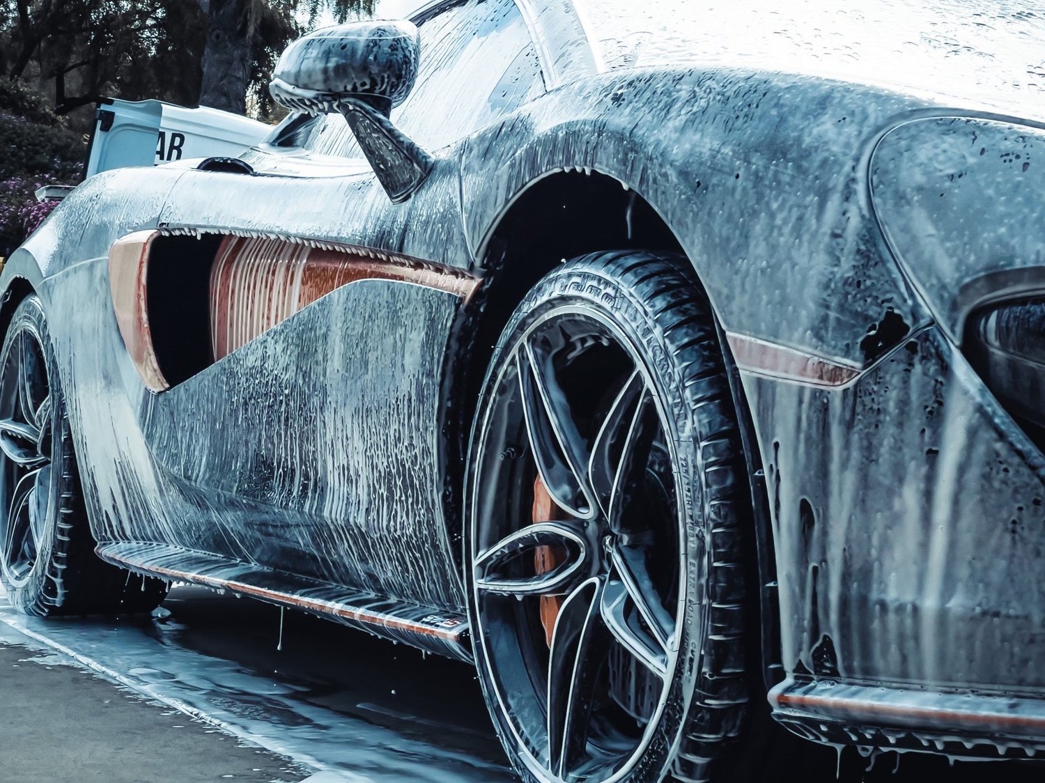 Sports car covered in wash foam during a NextGen Auto Detailing visit
